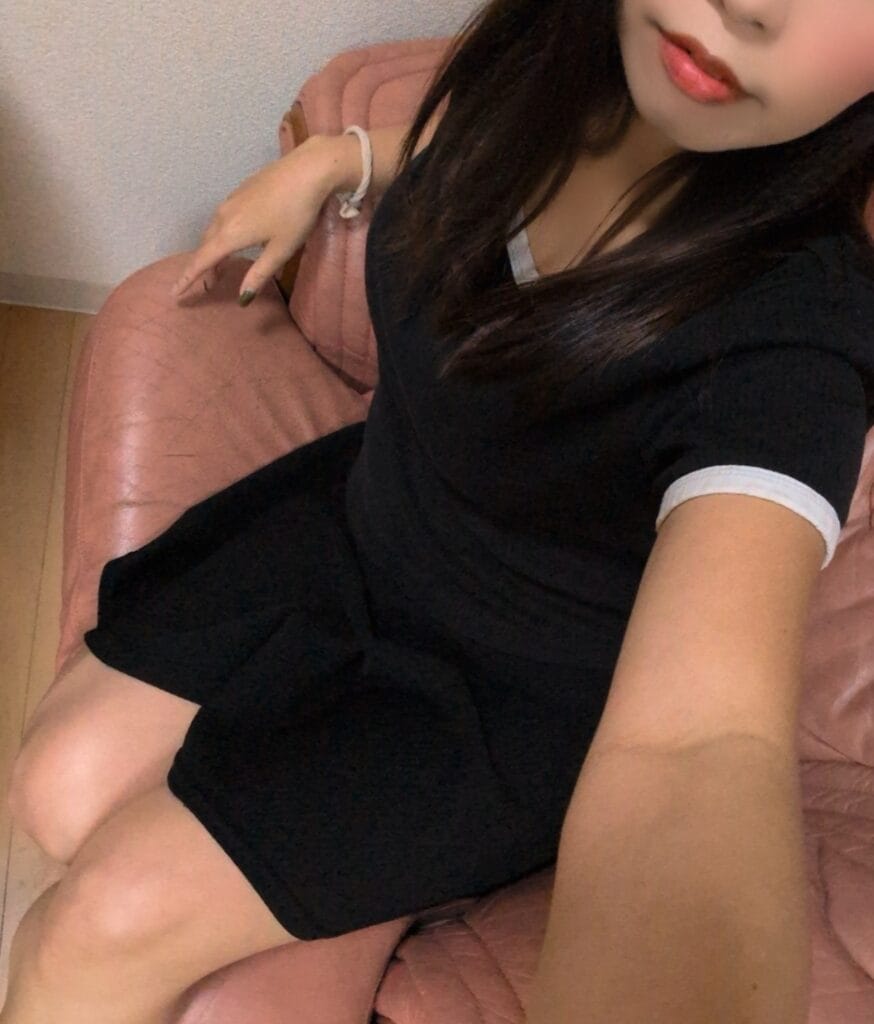 a woman sitting on a pink chair