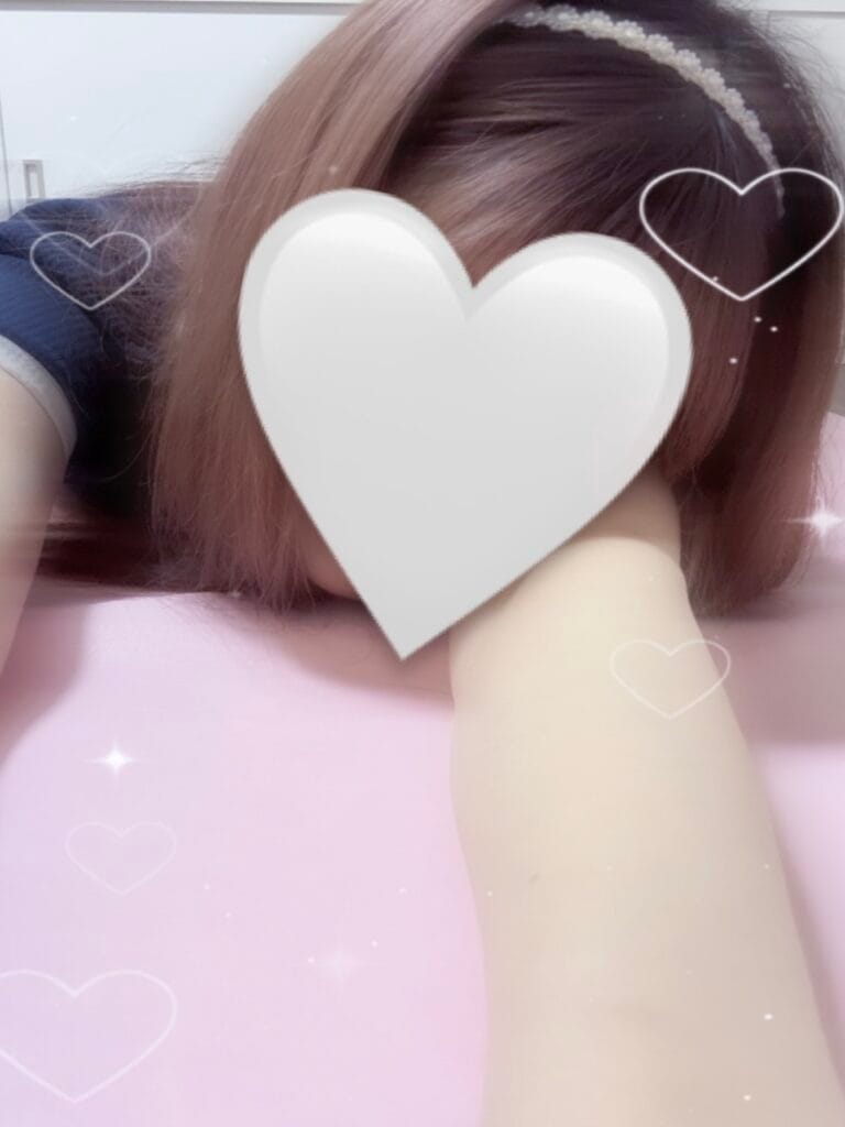 a person lying on a pink surface with a heart shaped object